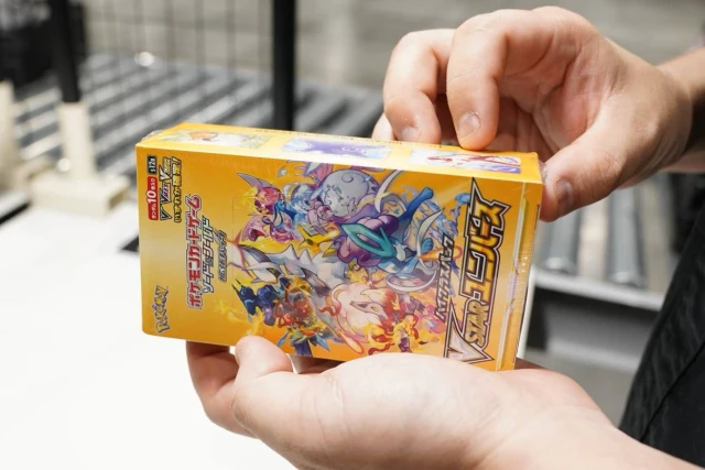Authenticator inspecting Japanese Pokemon booster box shrink wrap seal